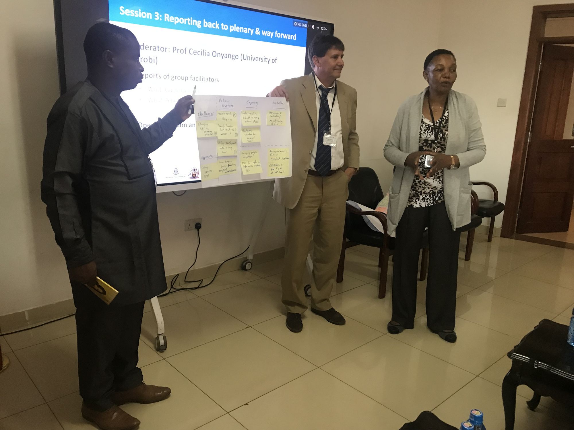 Mr Abiodun Aderibigbe, Mr Guido Geissler, and Mrs Daphne Muchai share the findings of the group work related to policies.